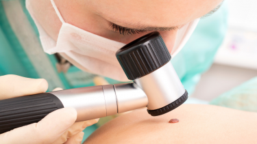 Dermatologist examining a patient