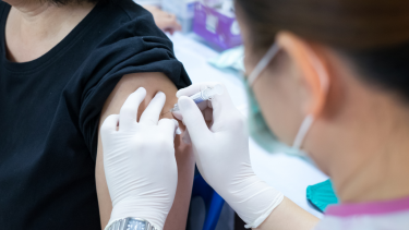 Healthcare provider administering a vaccine dose.