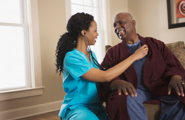 Photo of nurse with nursing home patient