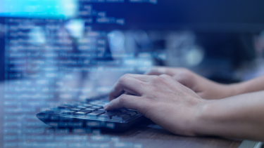 Photo of hands typing on keyboard