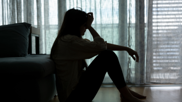 Person sitting in dark room